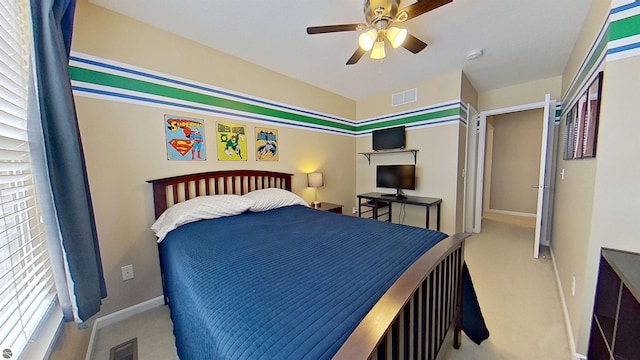 carpeted bedroom featuring visible vents, ceiling fan, and baseboards