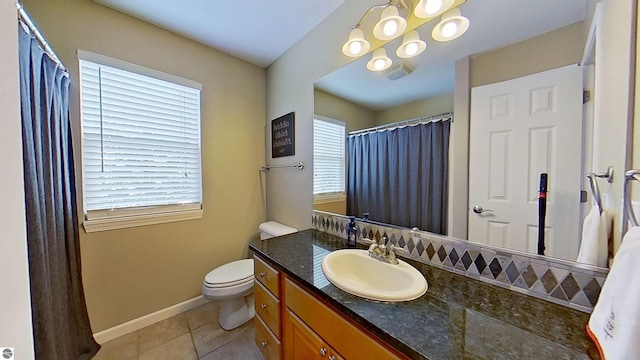 bathroom with tile patterned flooring, toilet, visible vents, vanity, and baseboards