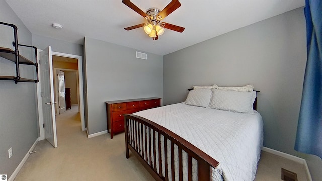 bedroom featuring light carpet, ceiling fan, visible vents, and baseboards