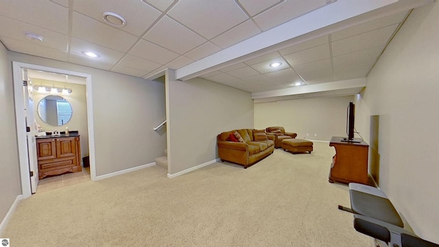 sitting room with carpet floors, baseboards, and stairway