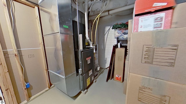 utility room featuring heating unit