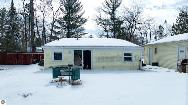 view of snow covered rear of property