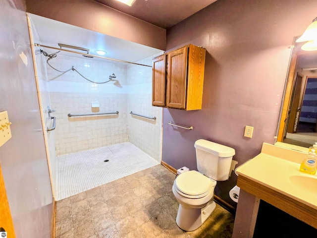 bathroom with a stall shower, vanity, and toilet