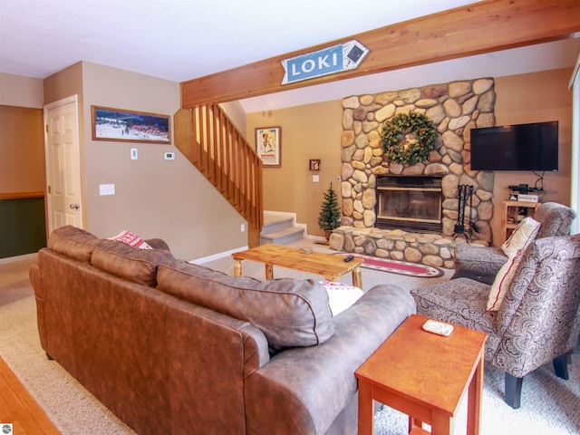 living room featuring carpet, a fireplace, stairway, beamed ceiling, and baseboards