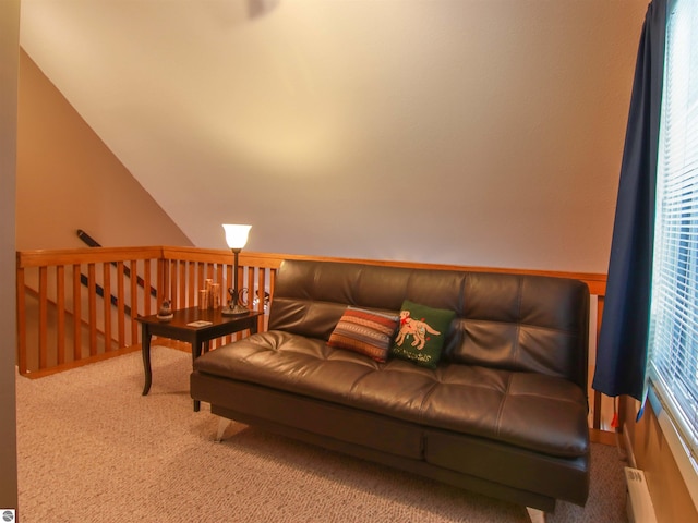 carpeted living area with lofted ceiling