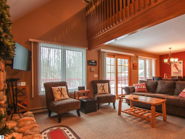 living area with a towering ceiling, a notable chandelier, and carpet flooring