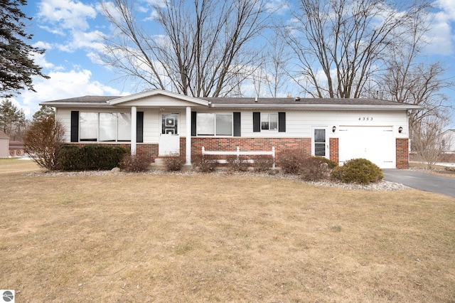 ranch-style house with a garage, driveway, brick siding, and a front lawn