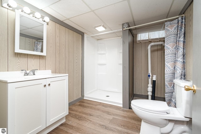 full bath featuring a paneled ceiling, curtained shower, wood finished floors, and vanity