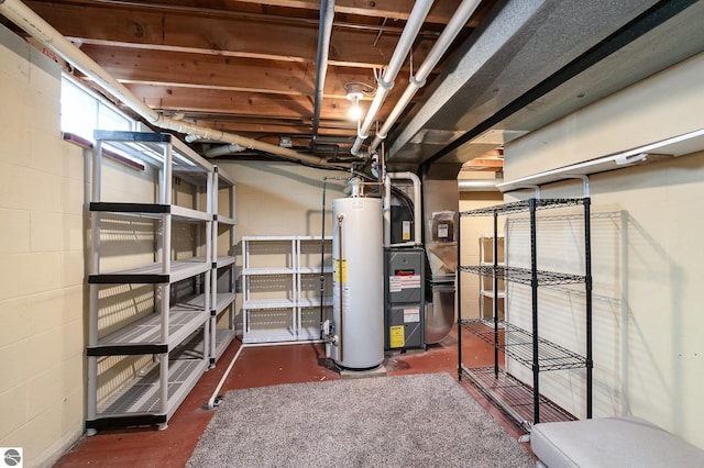 below grade area featuring water heater, concrete block wall, and heating unit