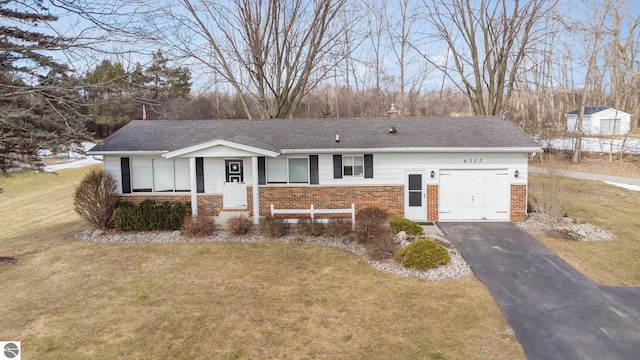 ranch-style house with aphalt driveway, an attached garage, brick siding, a shingled roof, and a front lawn