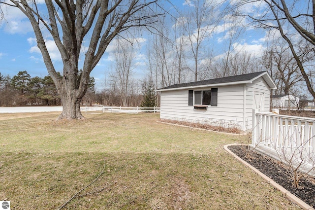 view of yard with fence and an outdoor structure