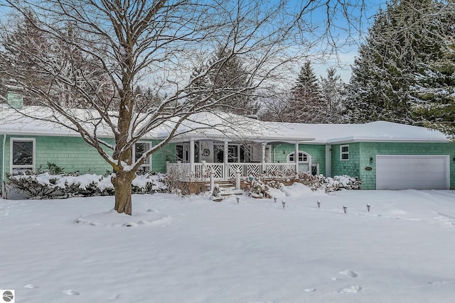 single story home with covered porch and an attached garage