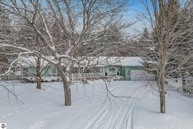 yard covered in snow with an attached garage