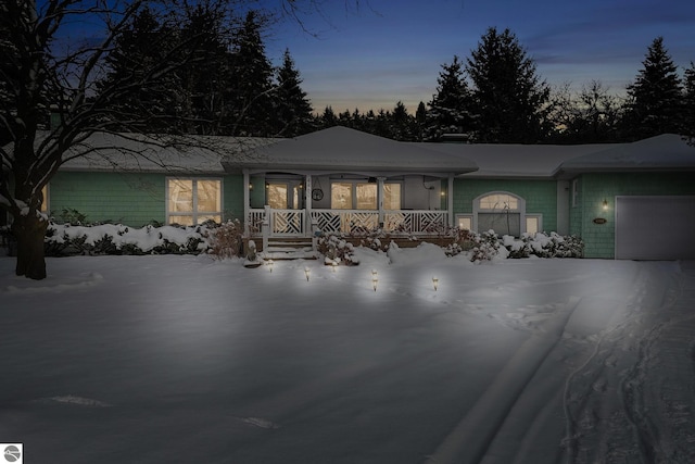 ranch-style home with a garage and covered porch