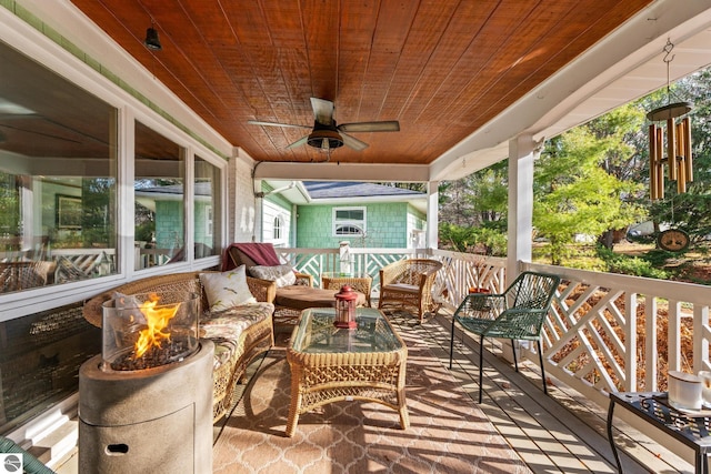 wooden deck with ceiling fan and an outdoor living space