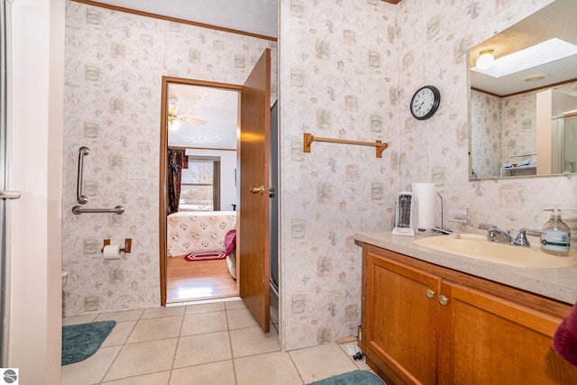 ensuite bathroom with vanity, wallpapered walls, ensuite bath, a textured ceiling, and tile patterned floors