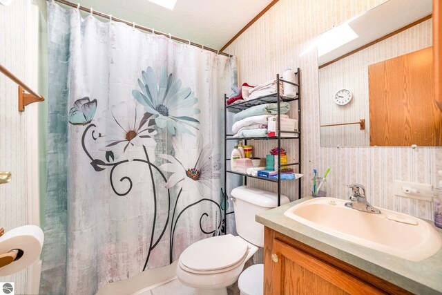 full bath featuring toilet, curtained shower, wallpapered walls, and vanity