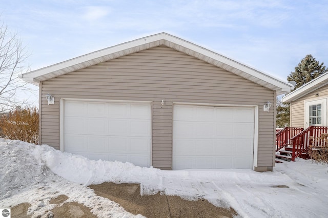 snow covered garage with a garage