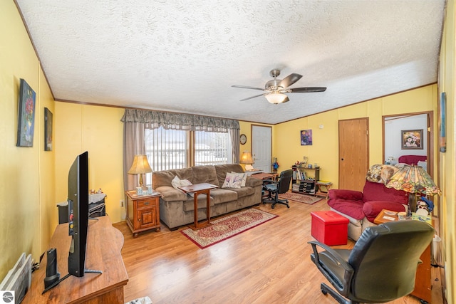 living area featuring light wood-type flooring, a textured ceiling, crown molding, lofted ceiling, and ceiling fan