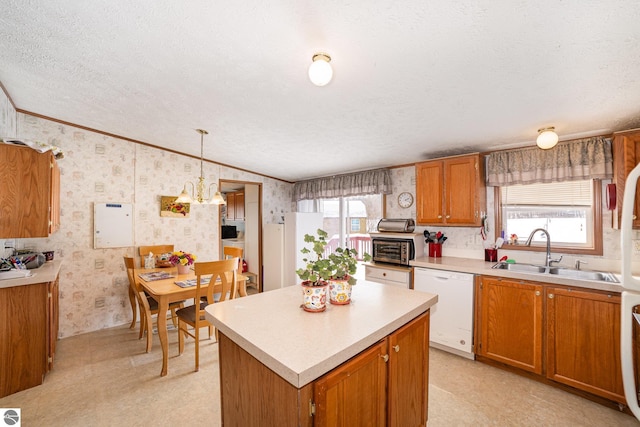 kitchen featuring wallpapered walls, a healthy amount of sunlight, white dishwasher, and a sink