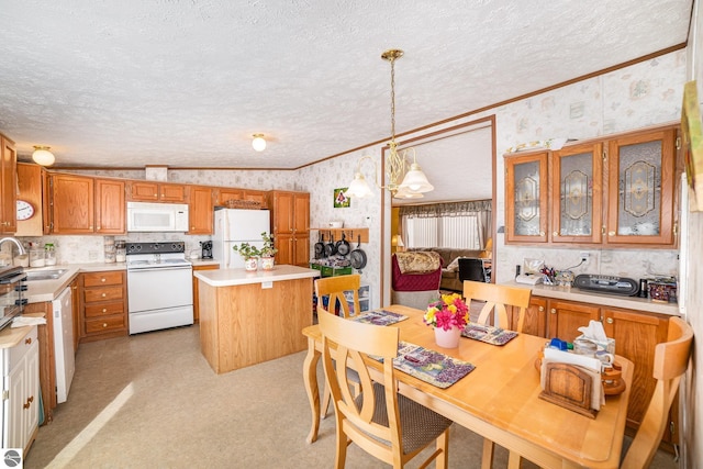 kitchen featuring white appliances, a textured ceiling, a kitchen island, and wallpapered walls