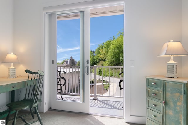 doorway with a wealth of natural light and carpet flooring