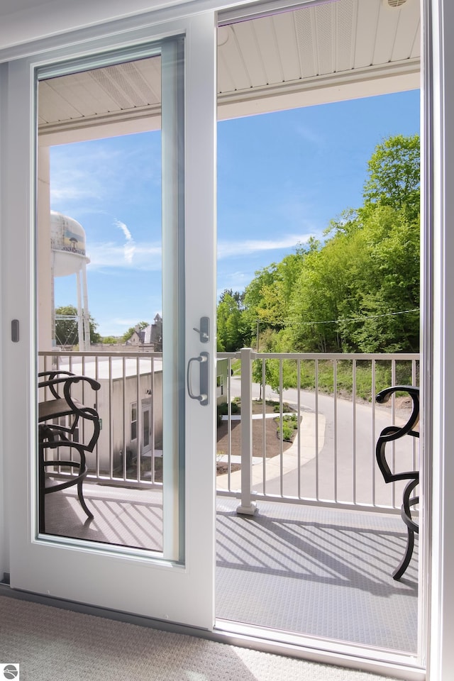 doorway to outside with carpet flooring