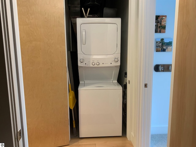 laundry room with stacked washing maching and dryer and laundry area