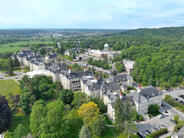 drone / aerial view featuring a wooded view