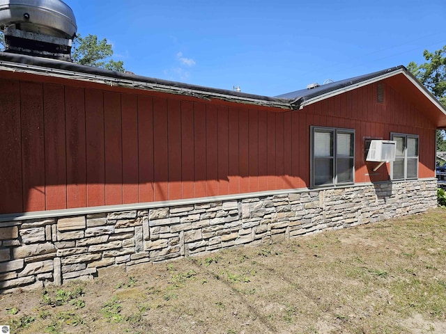 view of side of home featuring stone siding