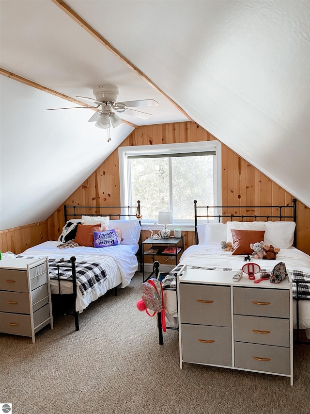 bedroom featuring carpet floors, vaulted ceiling, wood walls, and a ceiling fan