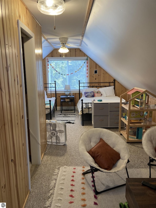 carpeted bedroom featuring wood walls and vaulted ceiling