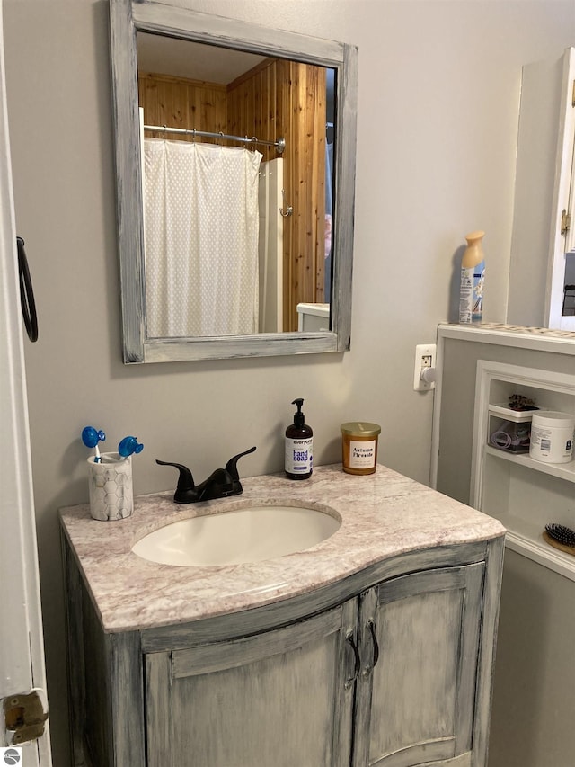 bathroom featuring curtained shower and vanity