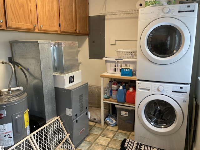 washroom with stacked washer and dryer, electric panel, cabinet space, and electric water heater