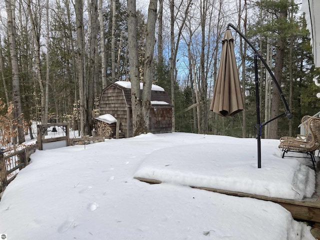 snowy yard with an outdoor structure