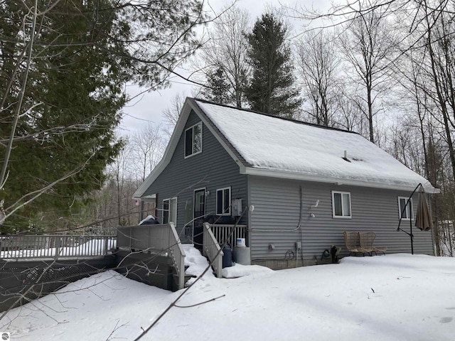 view of snowy exterior featuring a deck