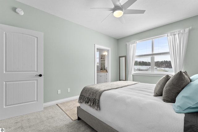 bedroom with carpet floors, baseboards, a ceiling fan, and ensuite bathroom