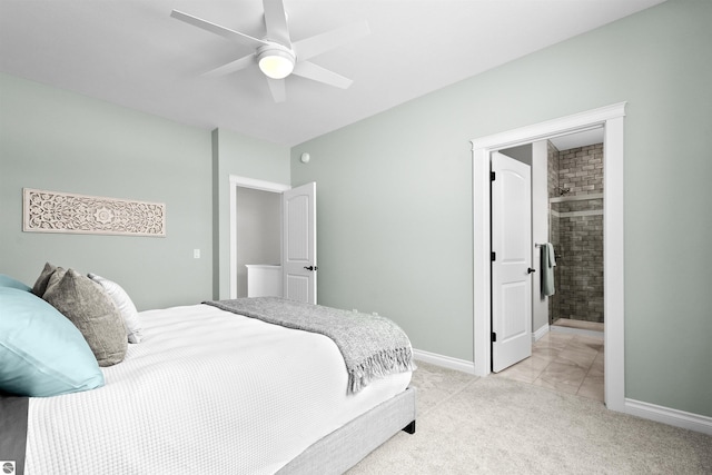 bedroom with a ceiling fan, light carpet, ensuite bath, and baseboards