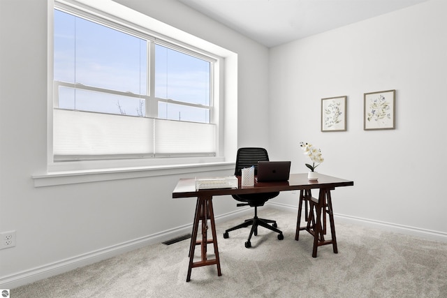 carpeted office featuring visible vents and baseboards