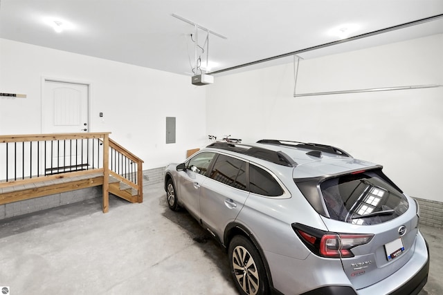 garage with a garage door opener and electric panel