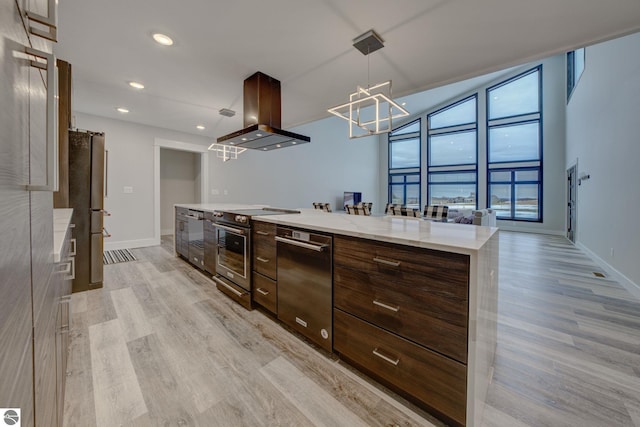 kitchen featuring light wood-style flooring, modern cabinets, stainless steel appliances, and island range hood