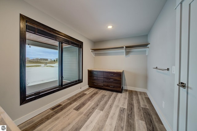 spacious closet with visible vents and light wood-style floors