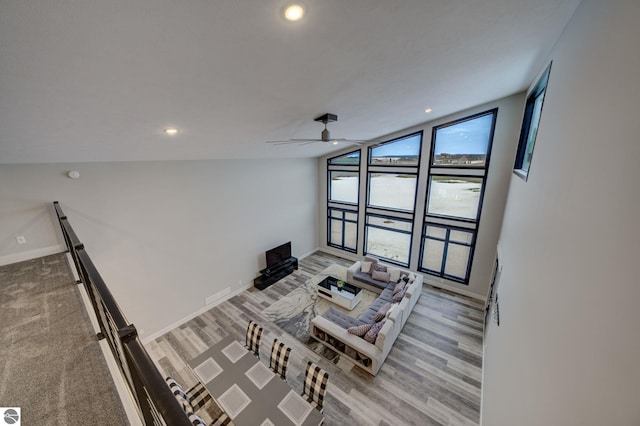 living area with a wall of windows, recessed lighting, and baseboards