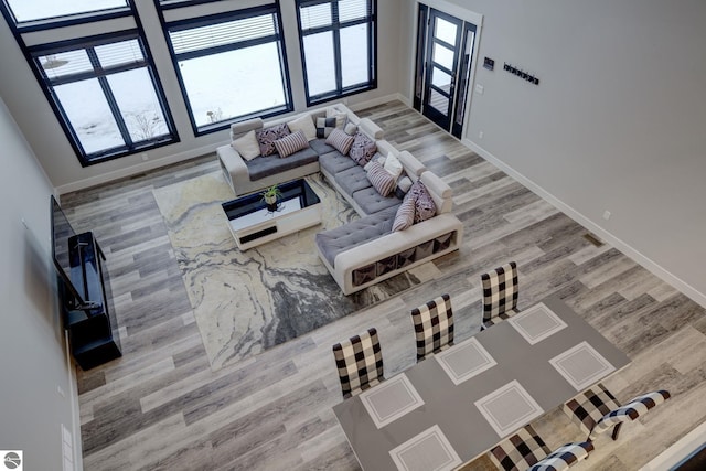 living room with baseboards and wood finished floors