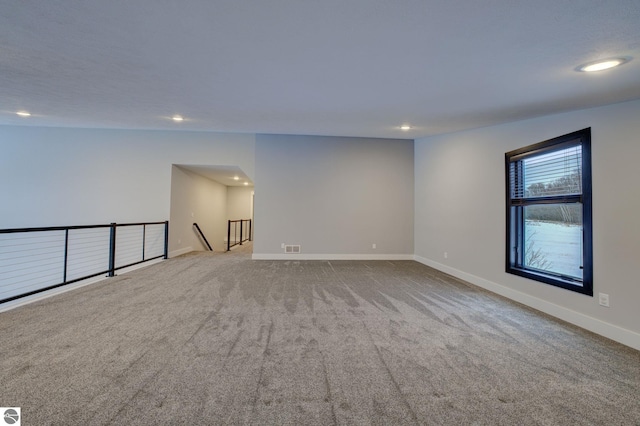 carpeted empty room with recessed lighting, visible vents, and baseboards