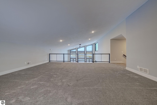 empty room featuring visible vents, carpet, baseboards, vaulted ceiling, and recessed lighting