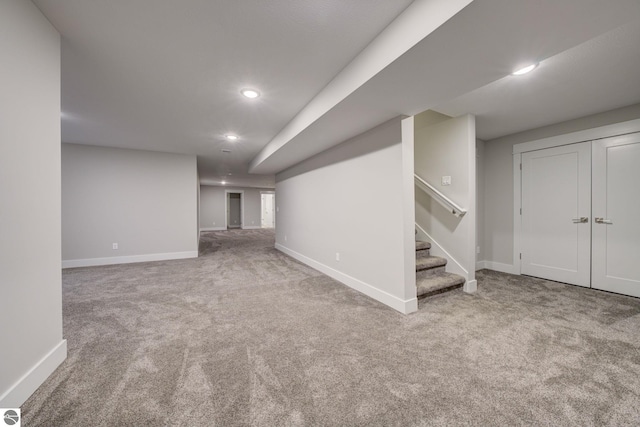 finished basement with recessed lighting, stairway, baseboards, and carpet