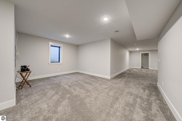 carpeted spare room featuring recessed lighting, visible vents, and baseboards