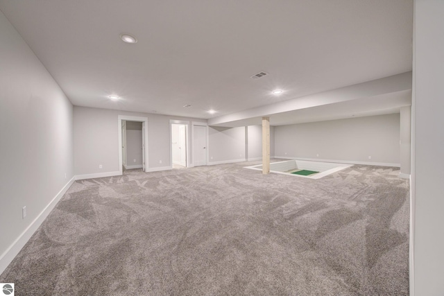 finished below grade area featuring recessed lighting, visible vents, baseboards, and carpet floors