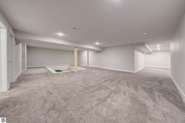 finished below grade area featuring visible vents, recessed lighting, baseboards, and carpet floors